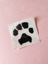 Load image into Gallery viewer, custom paw print vinyl sticker on backing sheet
